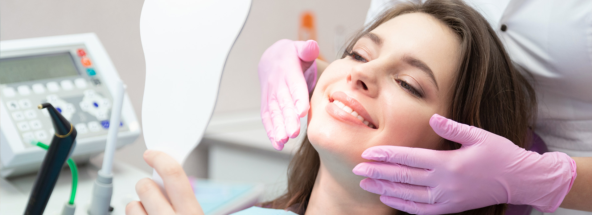 A woman receiving dental care with a smile on her face.