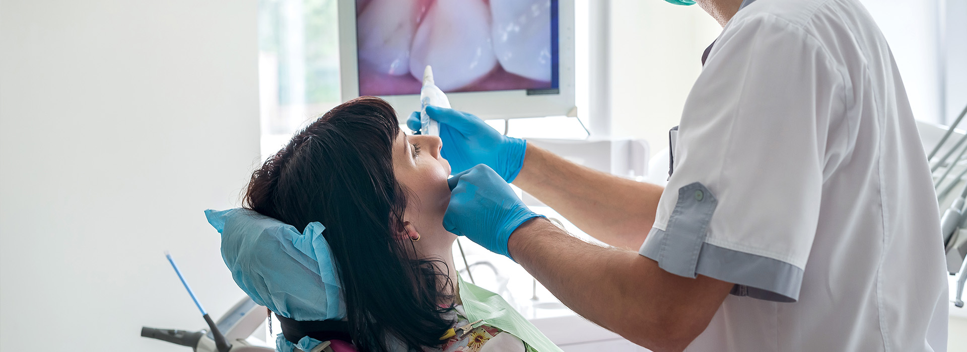 A person receiving dental care, with a dentist performing an examination or procedure.